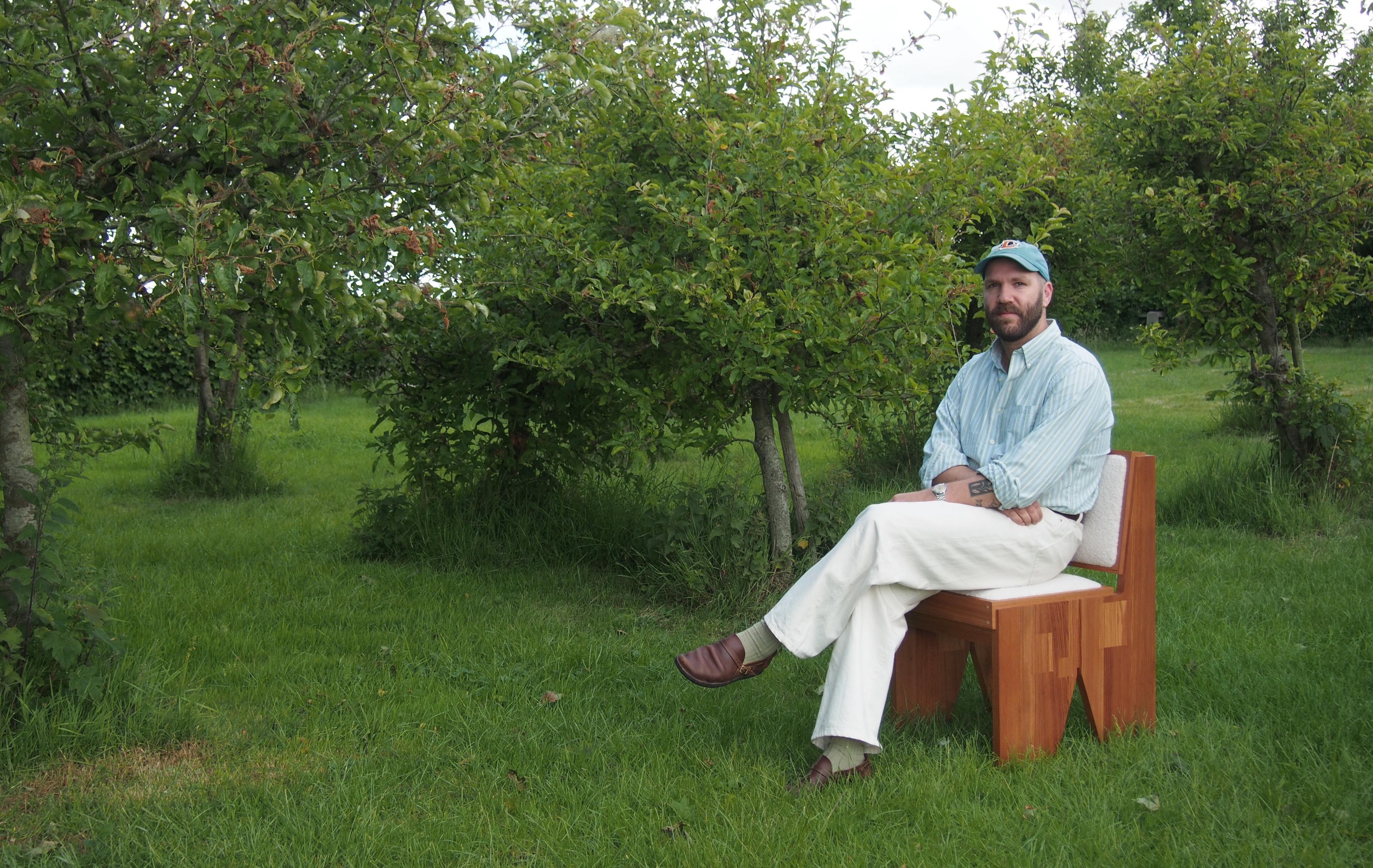 Kristian Kodde sitting on his wooden chair